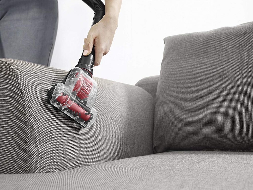 Ultra light weight black an decker vacuum cleaner used in cleaning the chair or couch