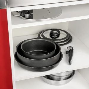 Stackable Tefal Ingenio pots and pans arranged neatly inside the cupboard